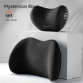 Black memory foam car headrest pillow and lumbar support pillow set on a car seat