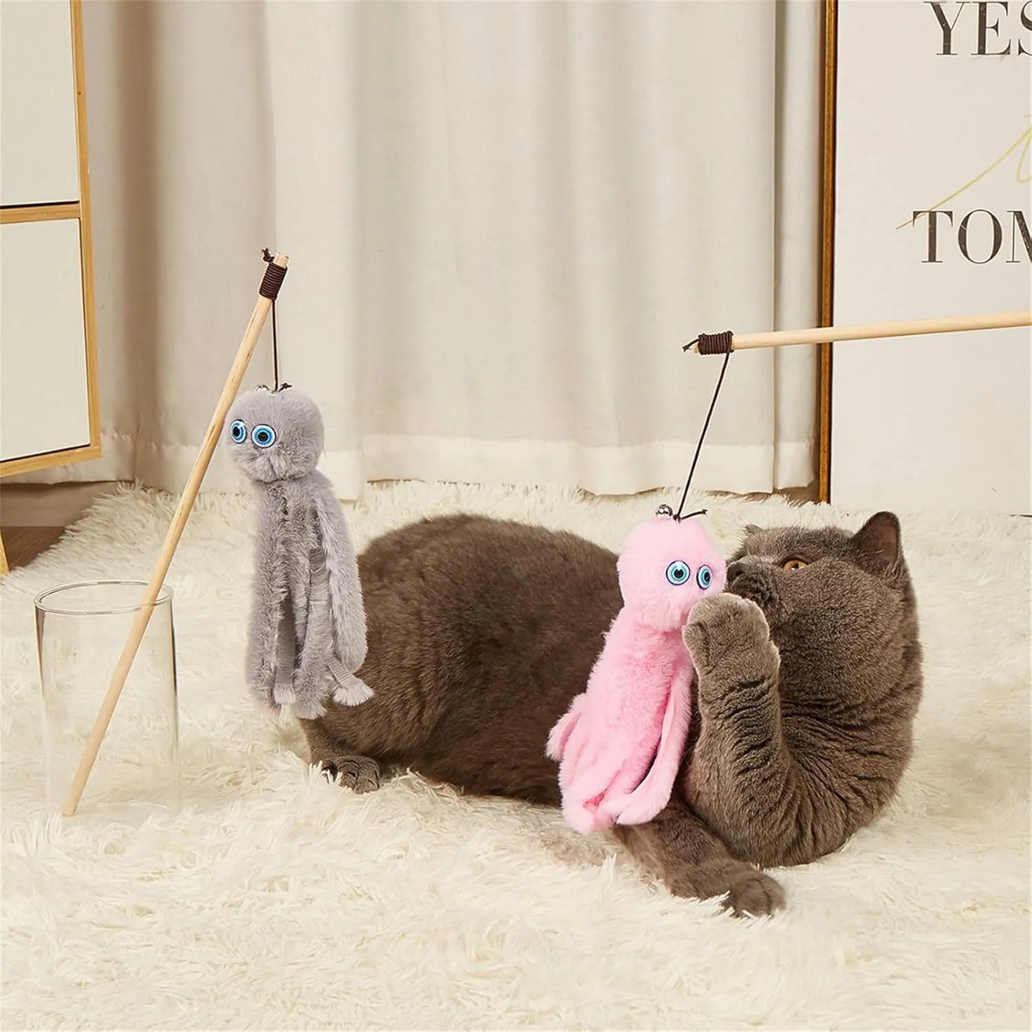 Octopus design cat toy with movable eyes on a long stick, shown in grey, pink, purple, or red.