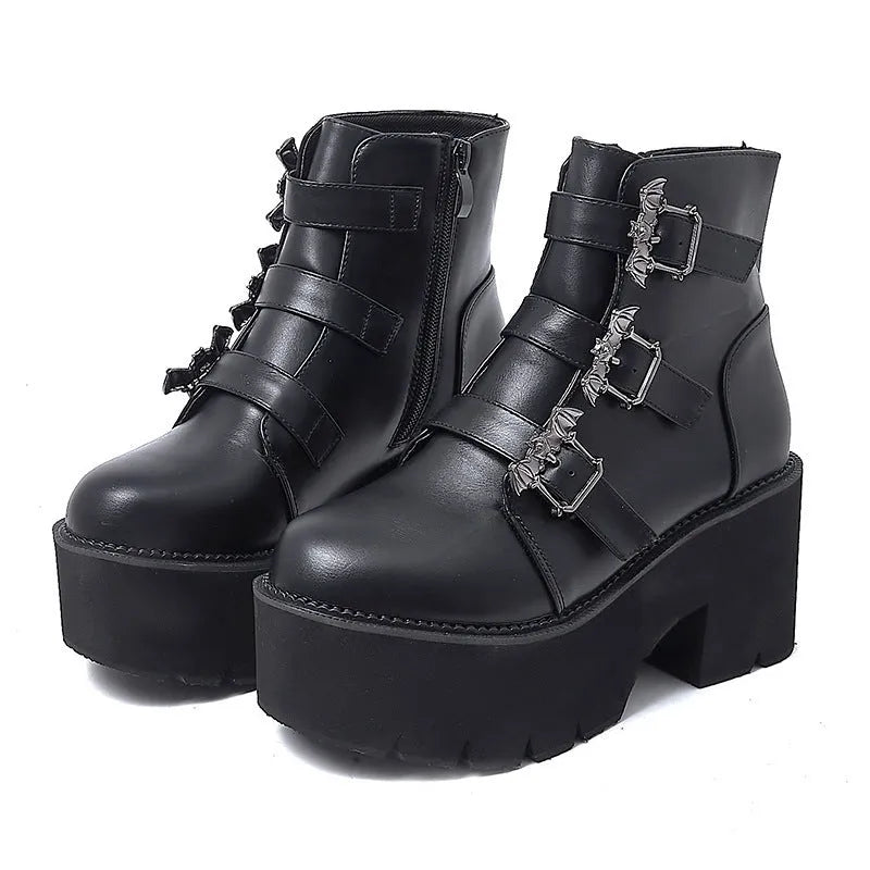 Black women's punk gothic Martin boots with bat buckle detail and side zipper.