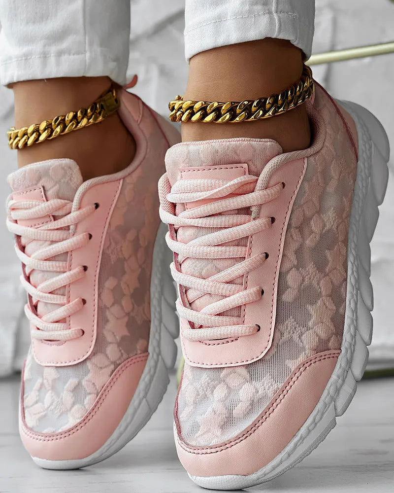 Women's white canvas running shoes with flat heel and round toe design on neutral background