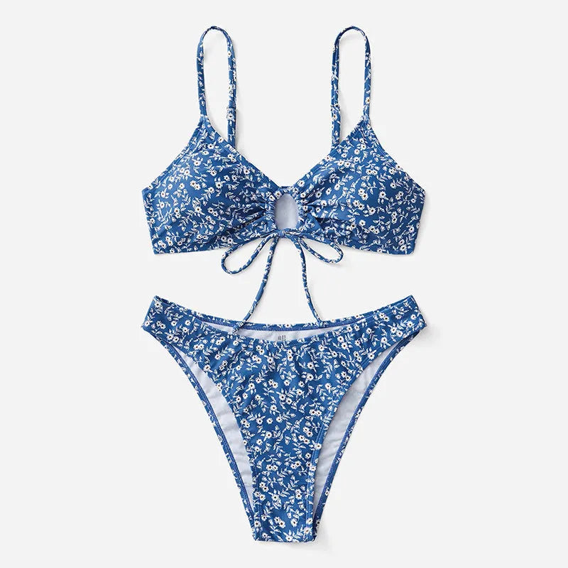 Blue women's three-piece swimsuit set with sleeveless top and shorts on a white background.