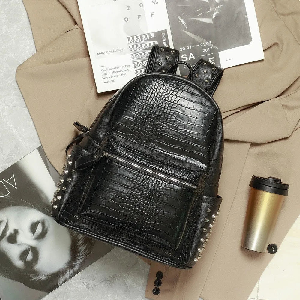 Black oil wax leather waterproof computer schoolbag with rivets, showing large 36-55L capacity.