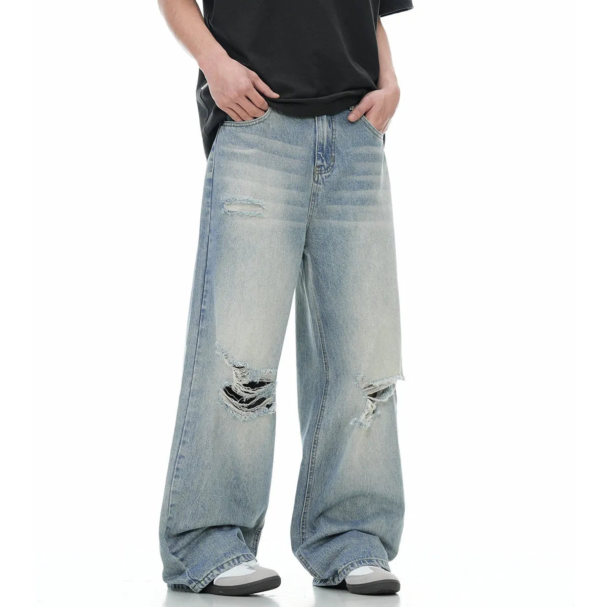 Blue men's straight-leg ripped jeans on a neutral background, showing zipper fly and cotton blend fabric texture.
