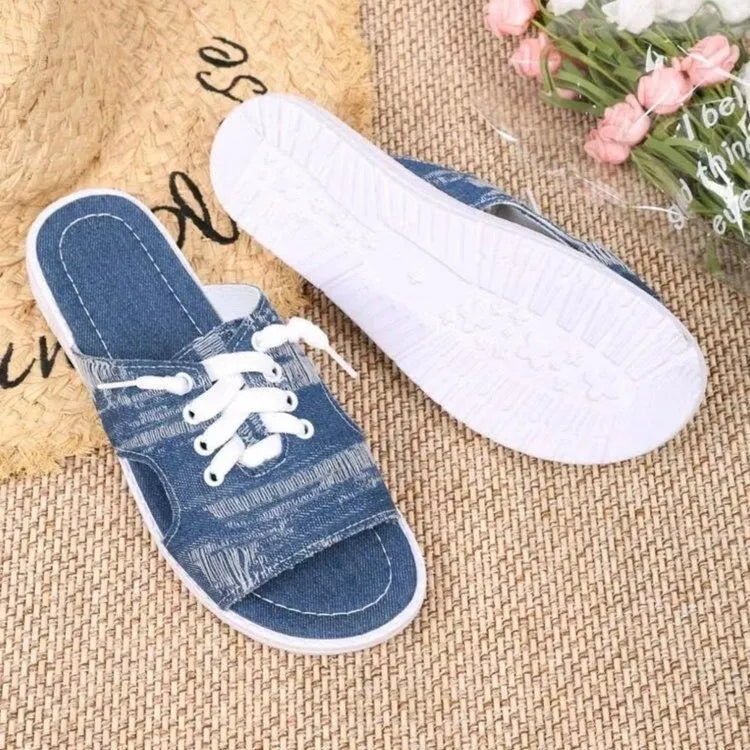 Blue women's Roman-style flat canvas slippers with a cloth upper and rubber sole.