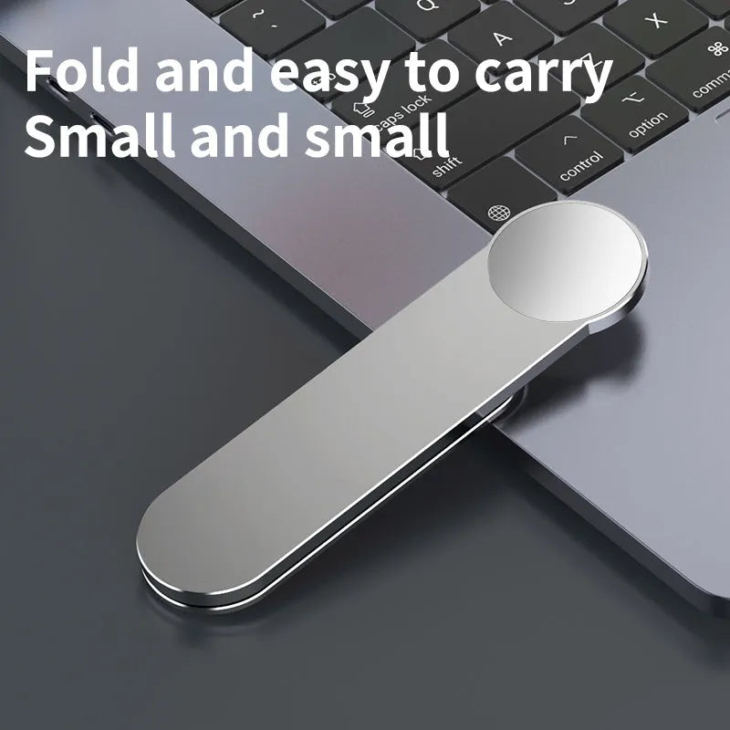 Silver aluminium alloy mobile phone bracket with magnetic attachment mounted next to computer screen