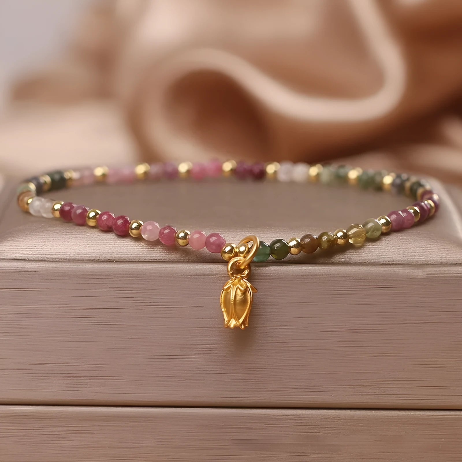 Natural tourmaline beaded anklet with flower-shaped stones on a delicate chain for women