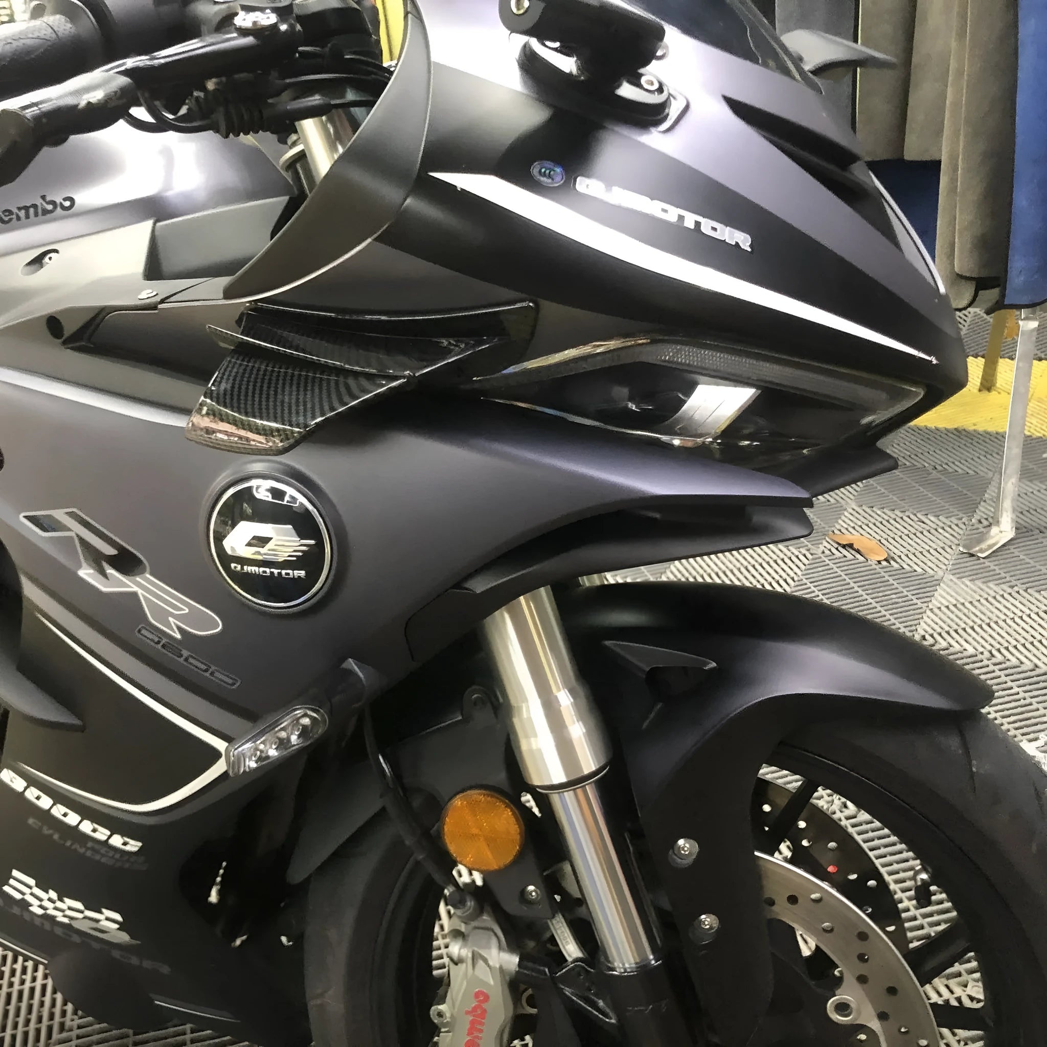 Set of two universal motorcycle spoiler wings for air diversion, showing four available finish options.