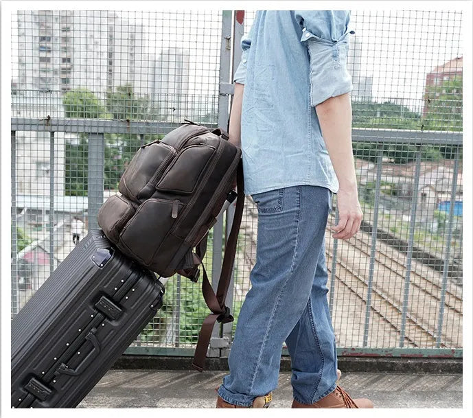 Dark brown retro leather backpack for a 17-inch laptop with double shoulder straps.