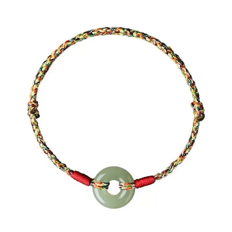 A woven bracelet with a peace buckle on a colourful braided rope.