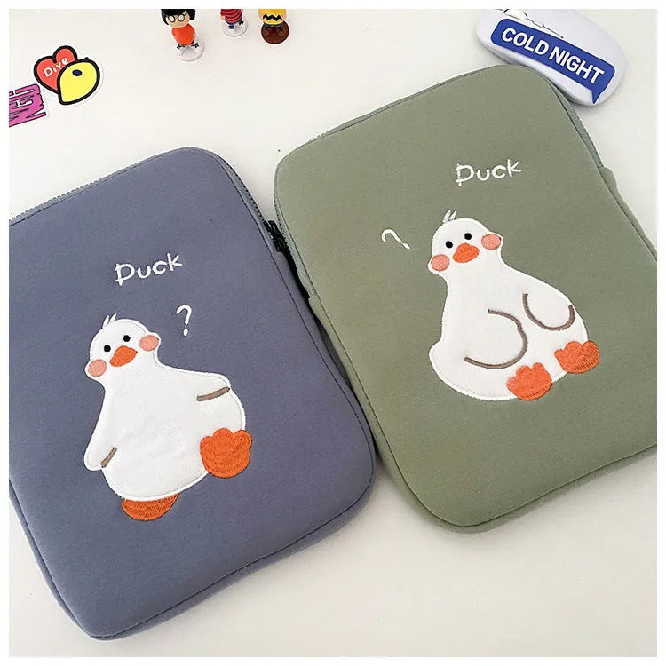 Blue cotton tablet case with embroidered cartoon duck design and a zipper closure.