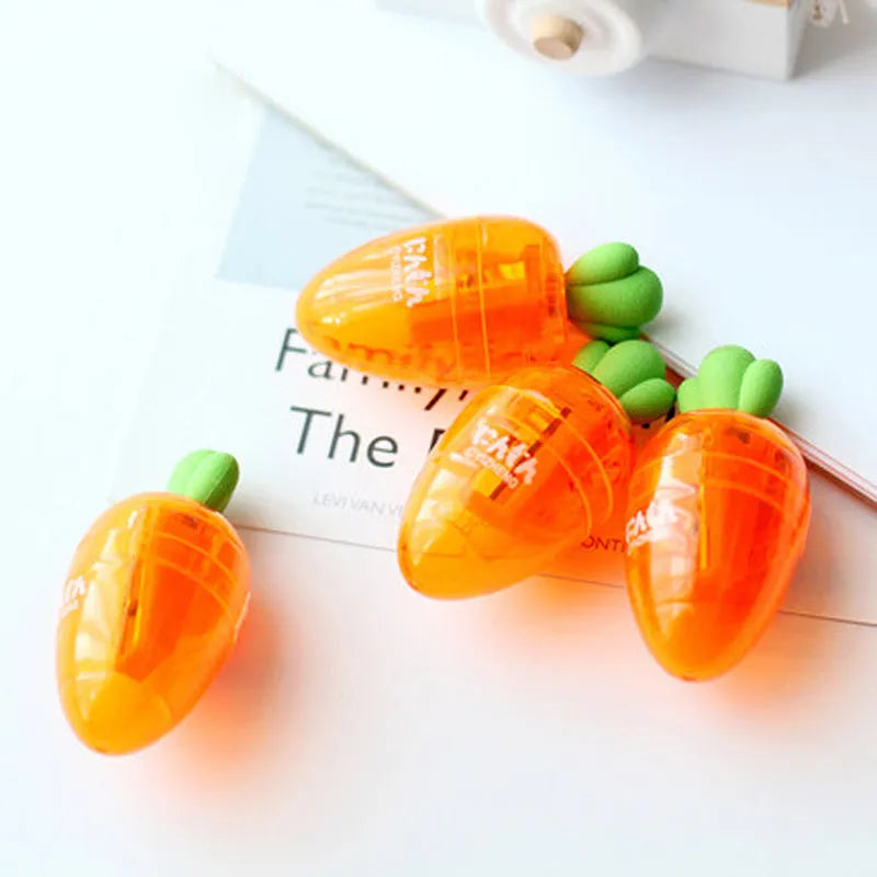 Carrot-shaped orange plastic pencil sharpener with green top, showing compact size next to pencil