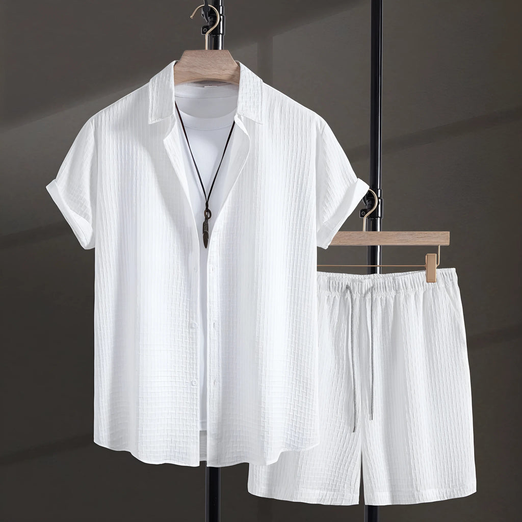 Men's black cotton blend short sleeve shirt and shorts beach suit laid flat.