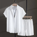 Men's black cotton blend short sleeve shirt and shorts beach suit laid flat.