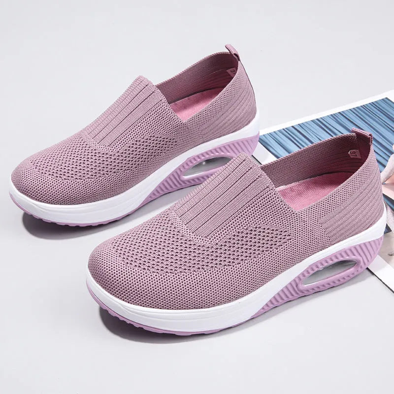 Women's beige casual running shoes with mesh upper and air cushion sole on a white background.