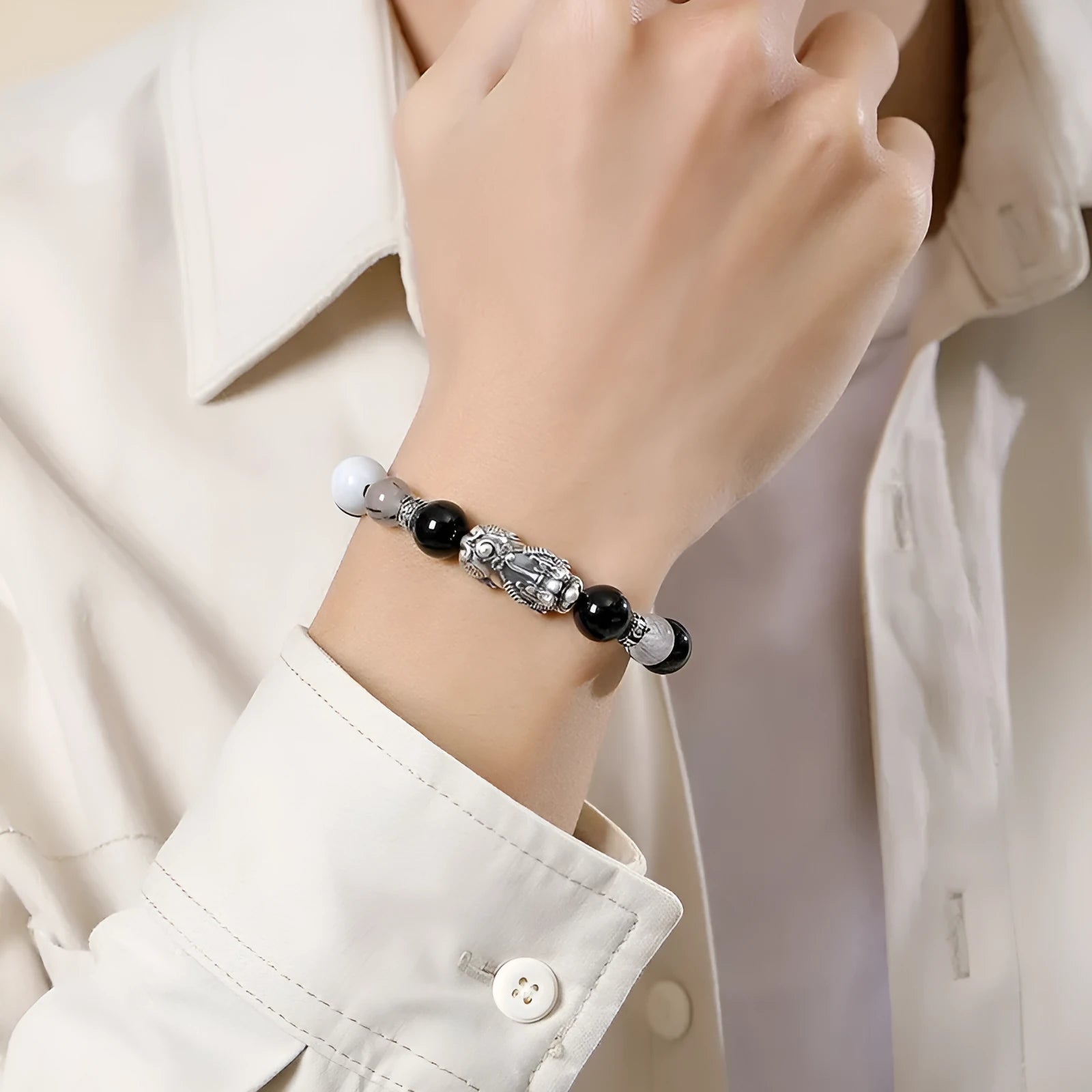 Hand-woven couple bracelet with sterling silver blessing card in black, white, or set, featuring animal and tassel details.