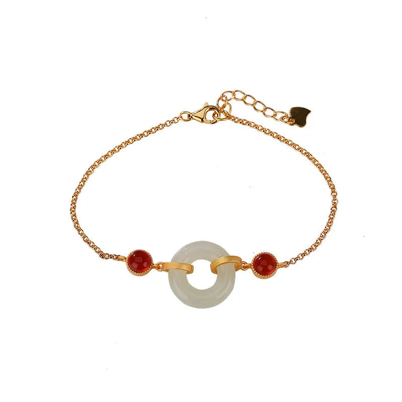 Gold-coloured women's bracelet with a silver and jade peace buckle on an adjustable chain.