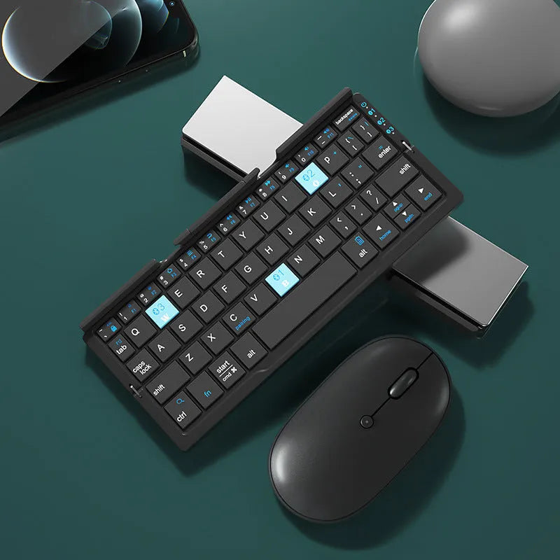 Silver and black grey foldable Bluetooth keyboard open with stand holding a mobile phone