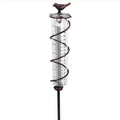 Glass rain gauge with cast iron hummingbird base for outdoor garden rainfall measurement.