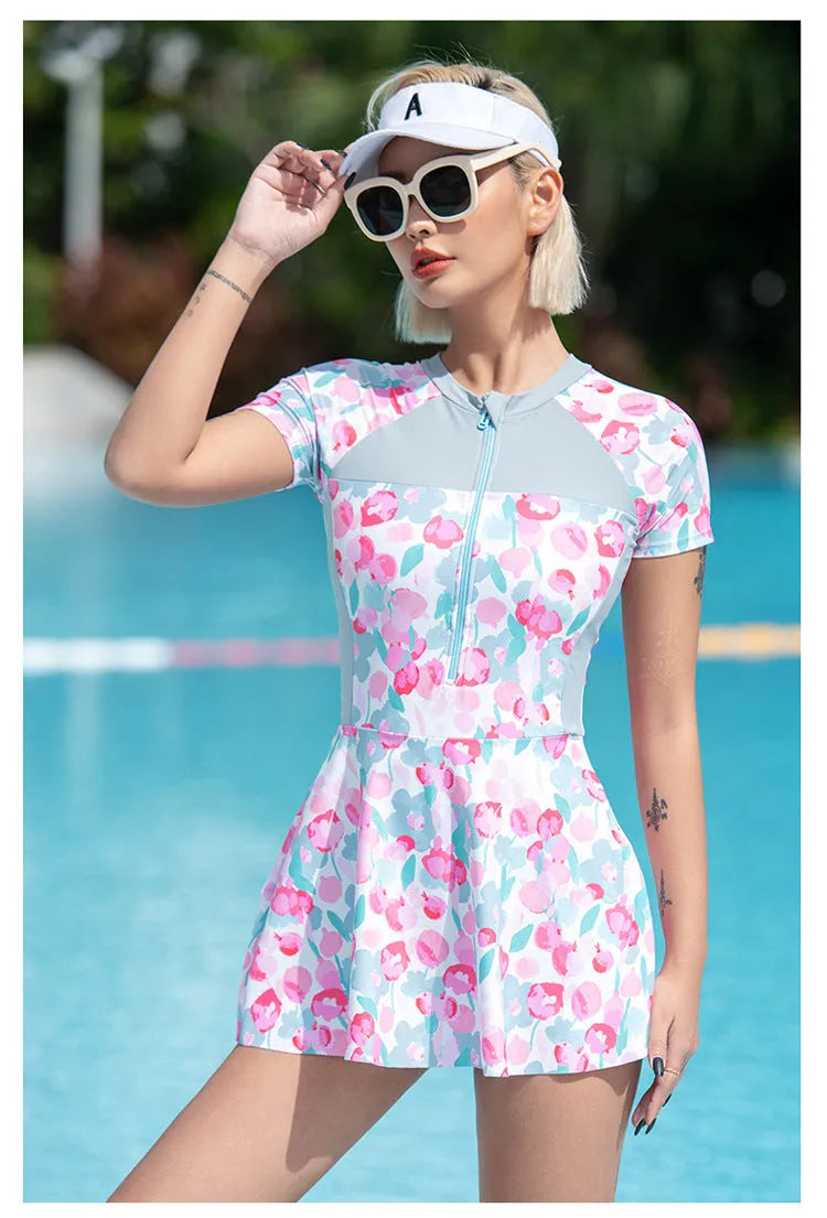 Plus size women's one-piece swimsuit with a printed colour pattern, shown on a mannequin.