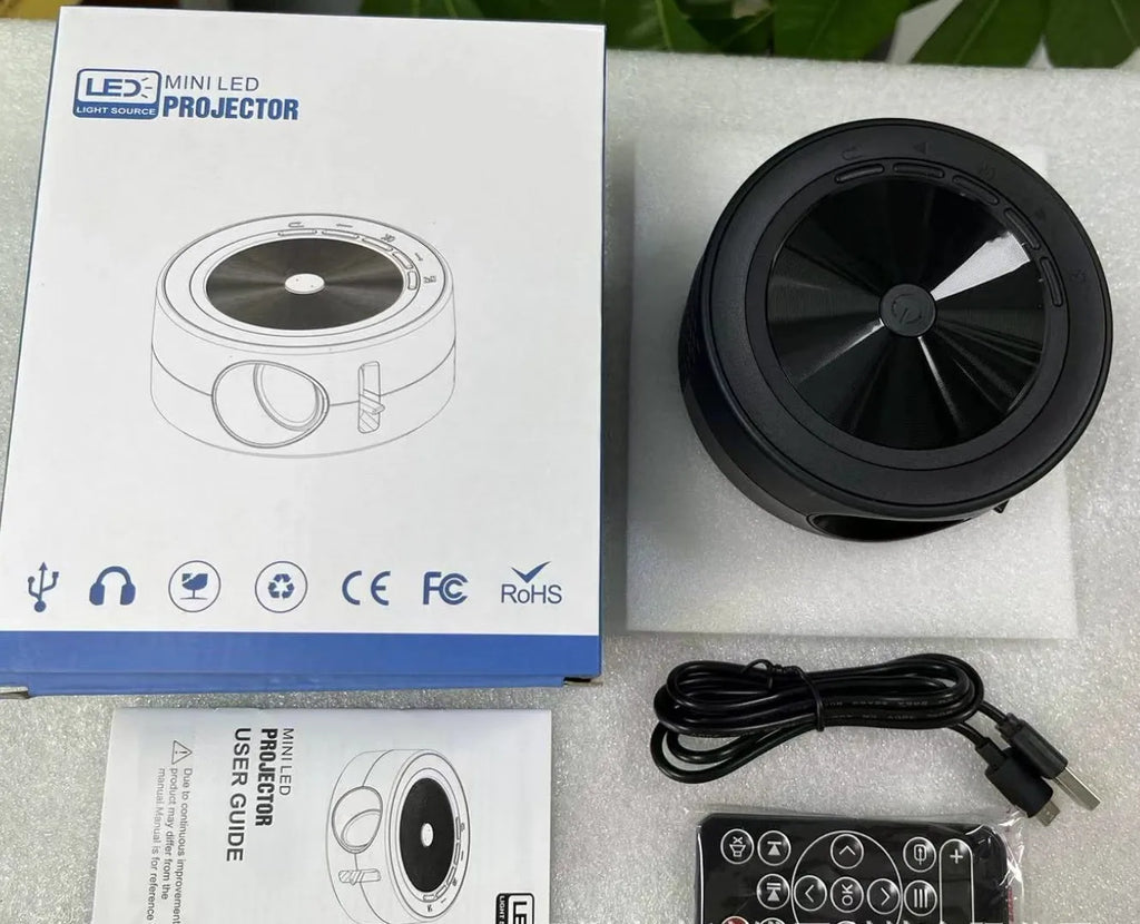 YT200 compact LED projector in black colour with remote control and USB cable