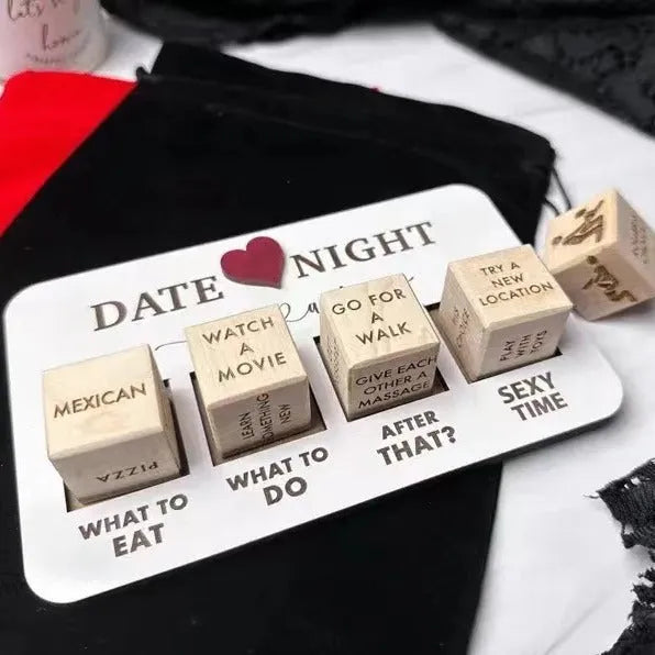 Wooden date night dice set with five natural wood dice on a rectangular planner board next to a black storage bag.
