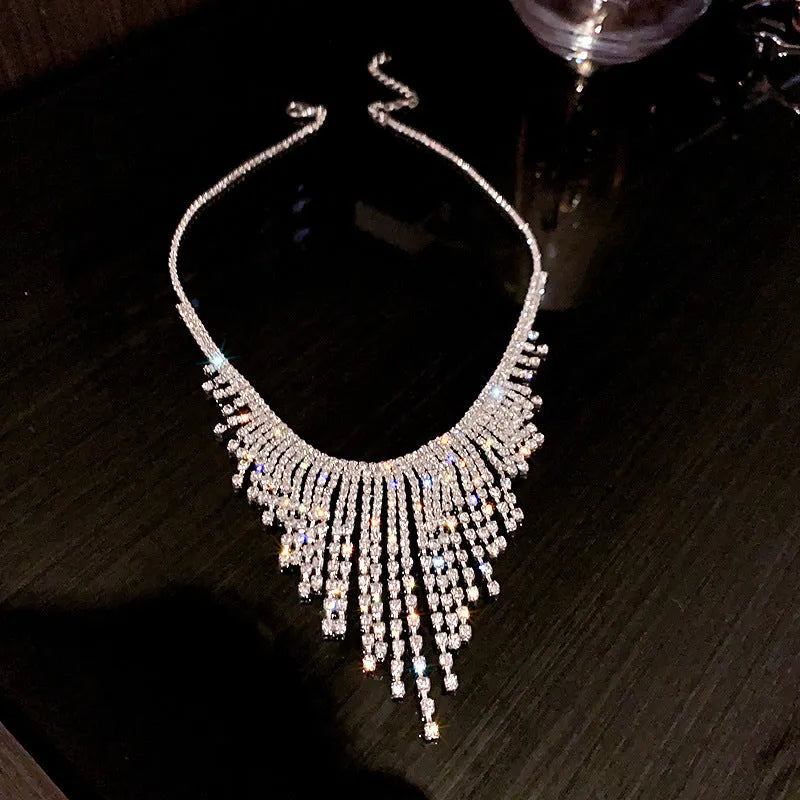 Silver alloy diamond tassel necklace with geometric pendant and ball bead chain on a woman