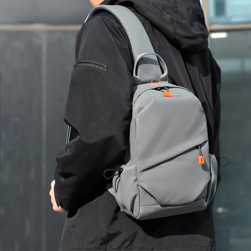 Men's black polyester crossbody bag worn on single shoulder with adjustable strap