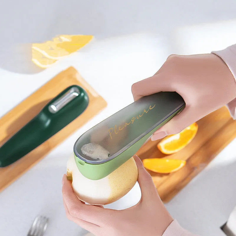 Dark green potato peeler with a removable storage tube and a stainless steel blade.