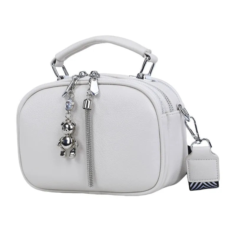 Oval-shaped women's small square shoulder bag in PU with double straps, shown in blue.