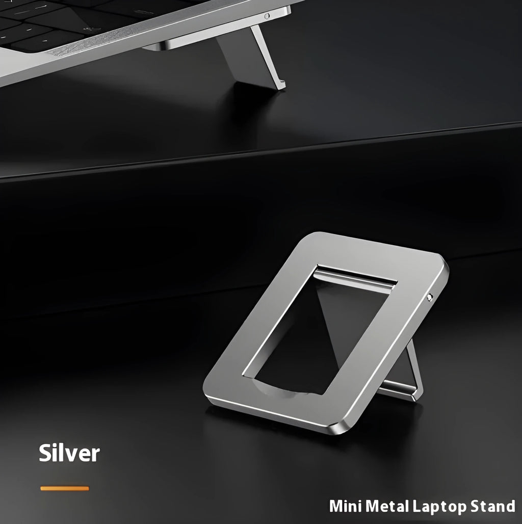 Small silver foldable aluminum laptop stand bracket with 3M adhesive strips on a white background.