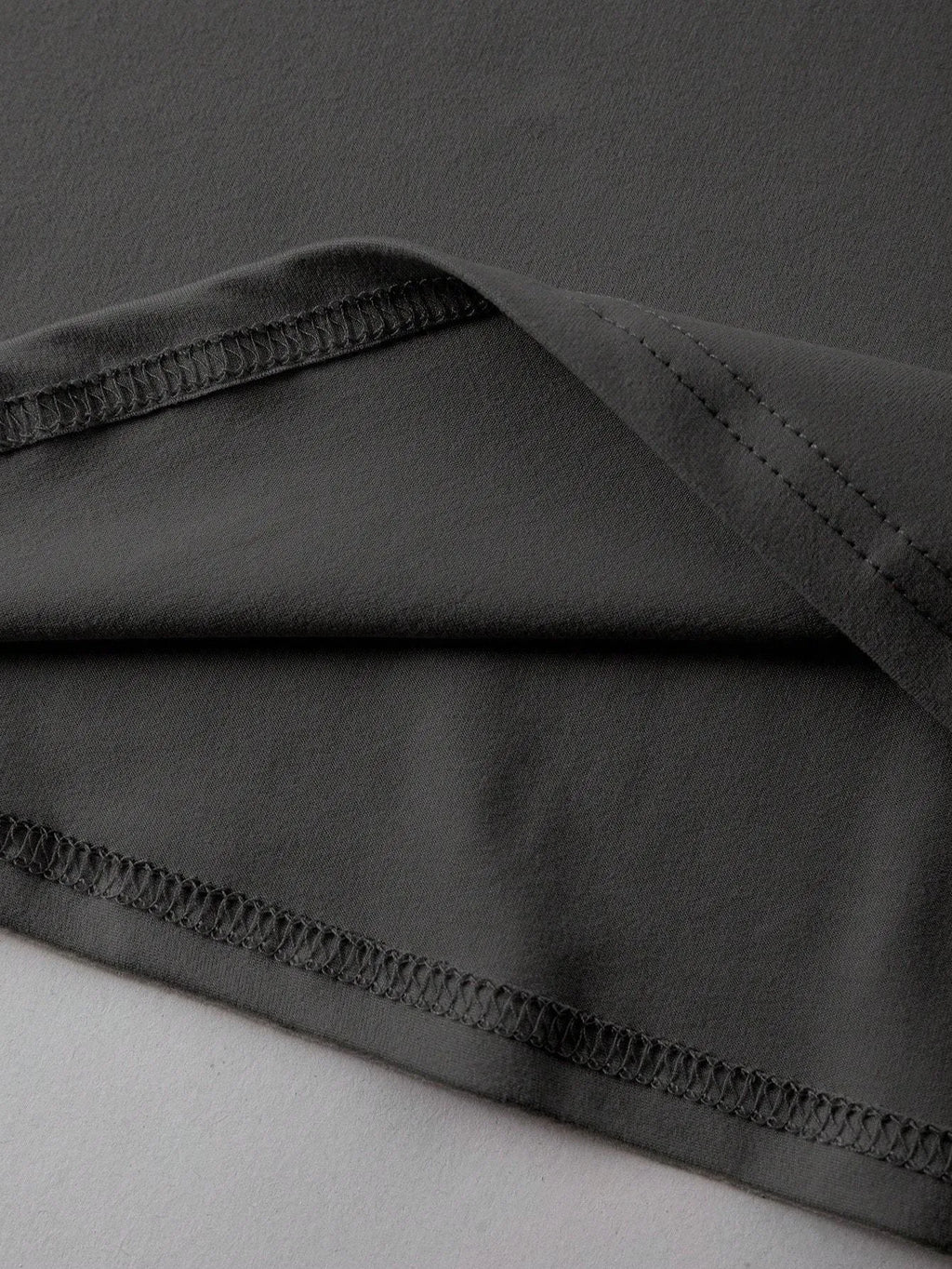 Unisex loose-fit cotton T-shirt in black, shown front-on, with short sleeves and a round neck.