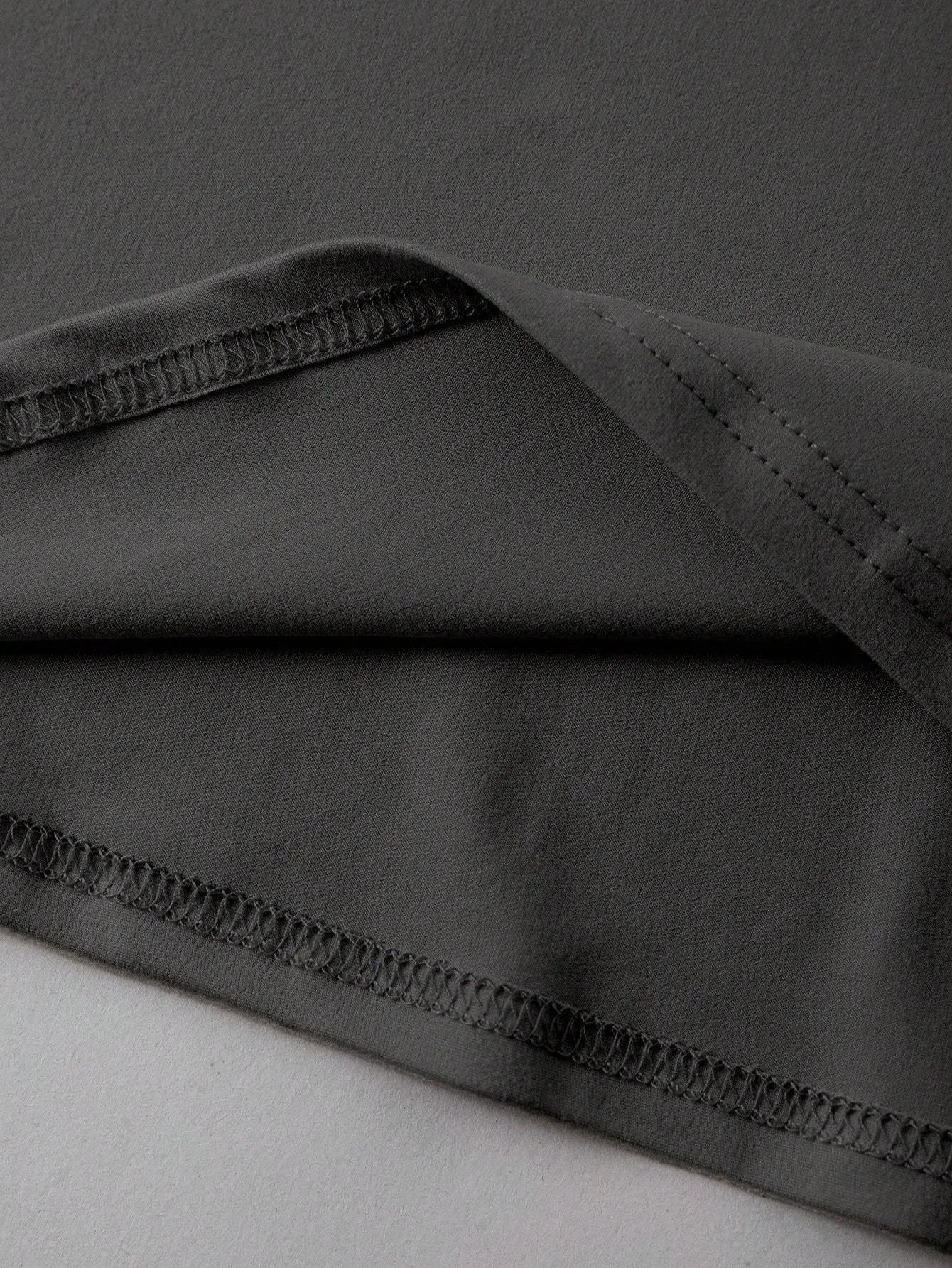 Unisex loose-fit cotton T-shirt in black, shown front-on, with short sleeves and a round neck.