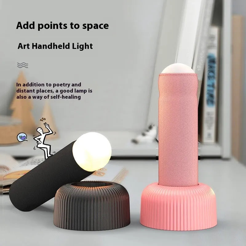 Handheld LED night light with fabric cover and base, warm light, black or pink, 92 x 193mm