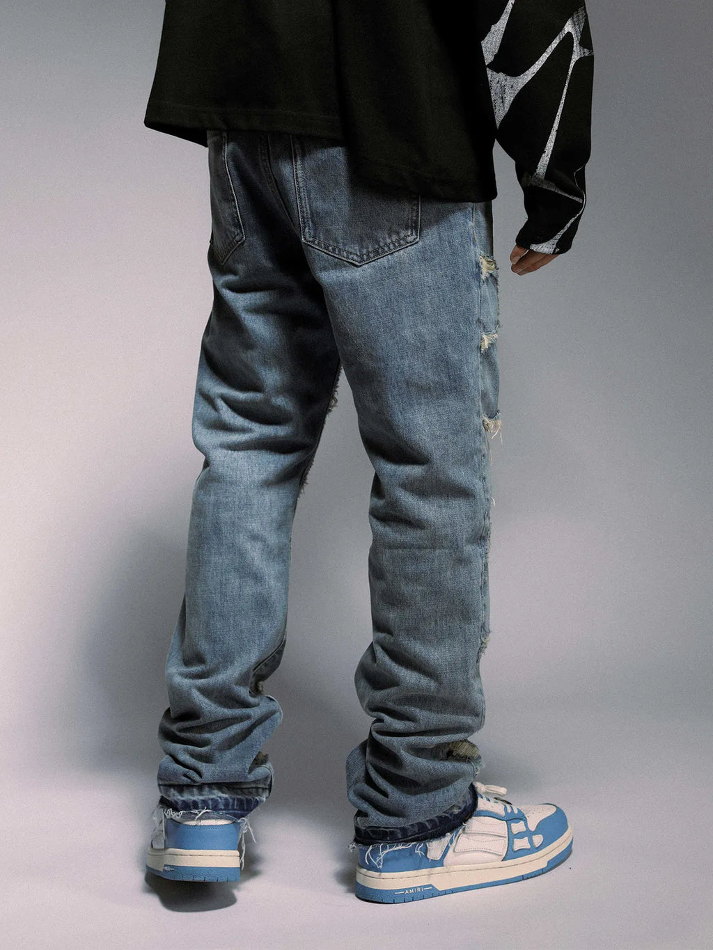 High street wash destroyed spider web straight leg jeans in light blue denim, mid-waist zipper front