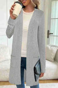 Women's plus size black knitted cardigan jacket with long sleeves and front pockets.