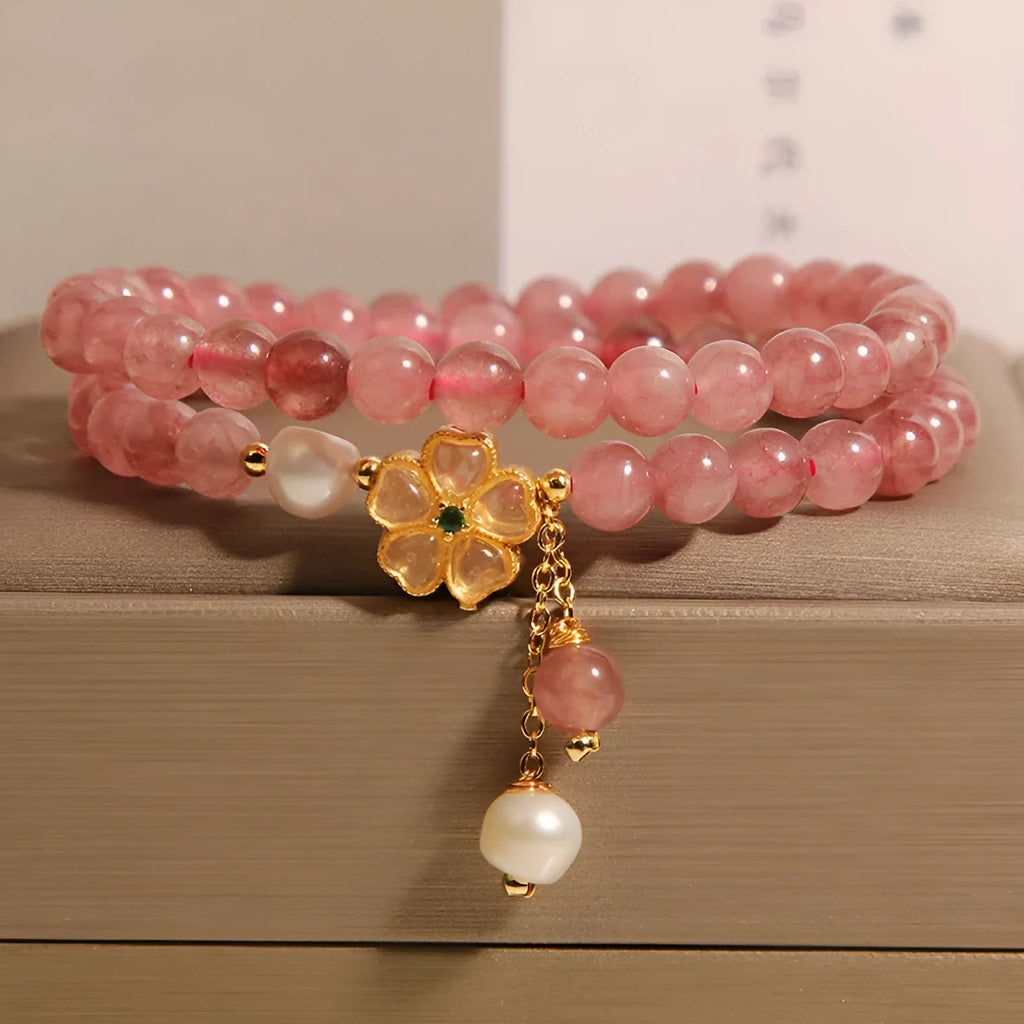 Double ring women's bracelet with strawberry quartz four-leaf clover charms and alloy gemstone details.