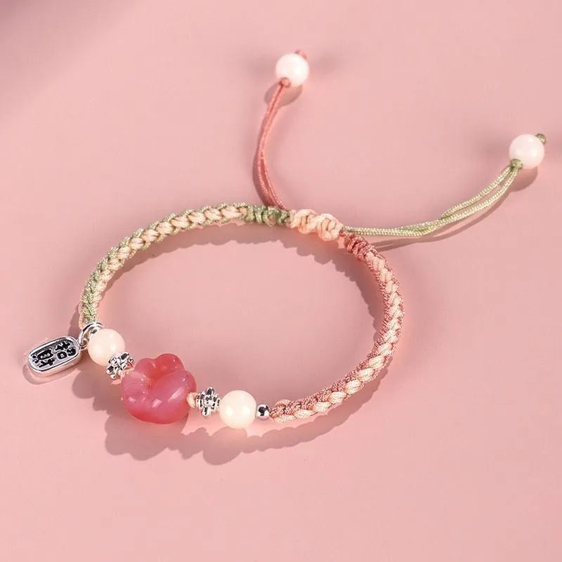 Red glass cat's paw charm bracelet with woven cord in pink or yellow for couples