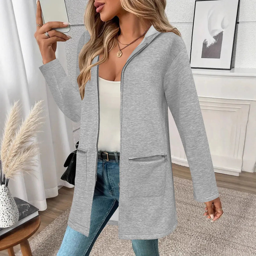 A loose grey mid-length cardigan coat for women with pockets, shown on a hanger.