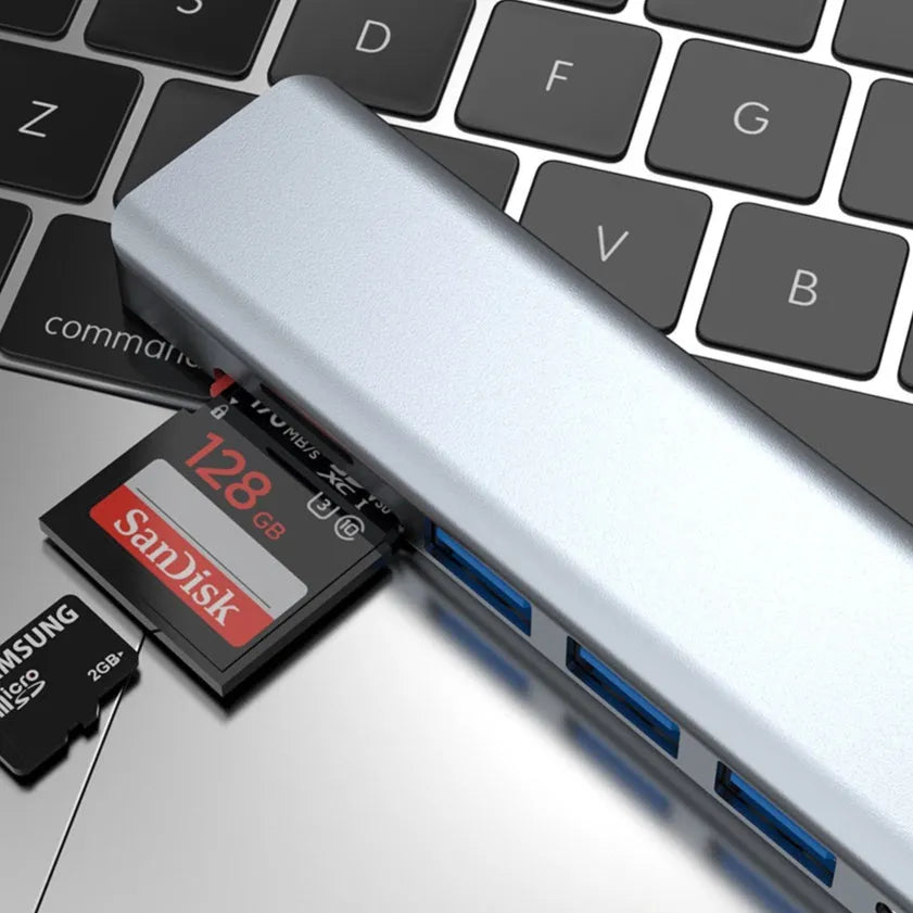 Seven-port USB expander with a short Type-C cable connected to a laptop.