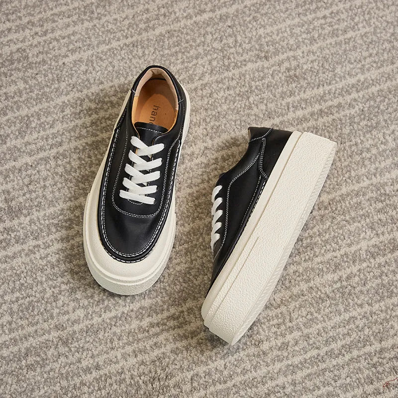 Women's black embossed cowhide platform sports board shoes with a rubber sole.
