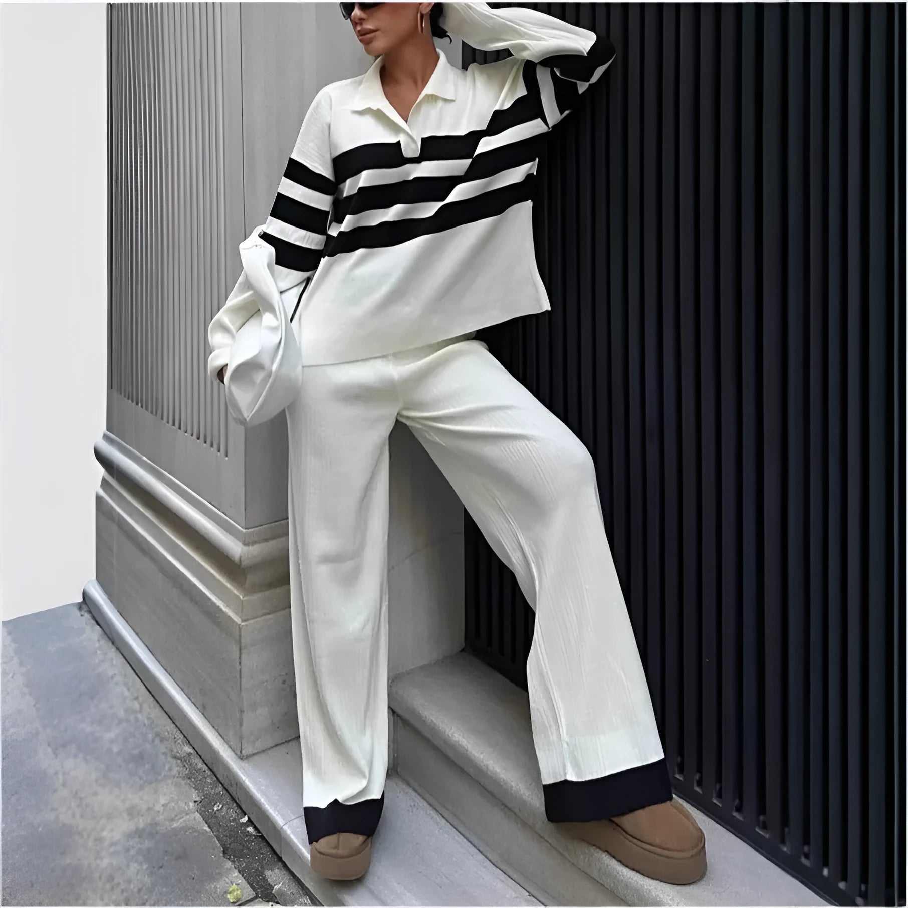 Women's black and white striped knitted polo collar two-piece set with long sleeves and trousers.