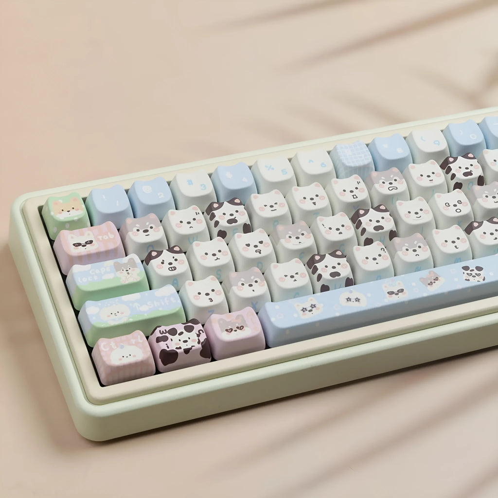 Full set of colourful PBT keyboard keycaps with sublimated cute puppy and cat designs laid out.