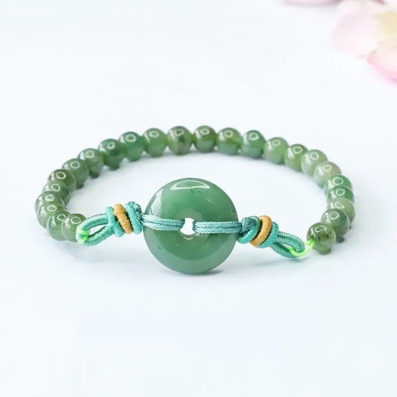 Natural emerald jade bracelet with star-shaped beads and a silver safety buckle.