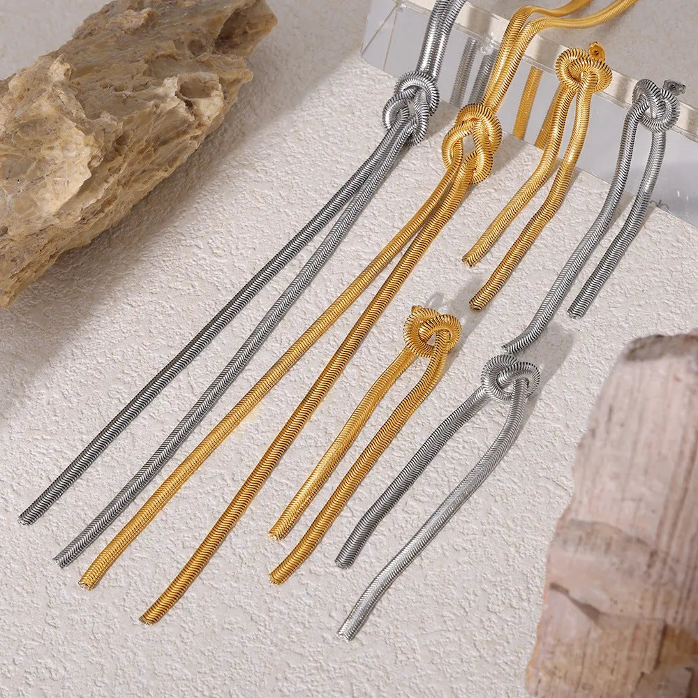 Gold electroplated titanium steel necklace with knotted tassel pendant on snake chain and matching earrings