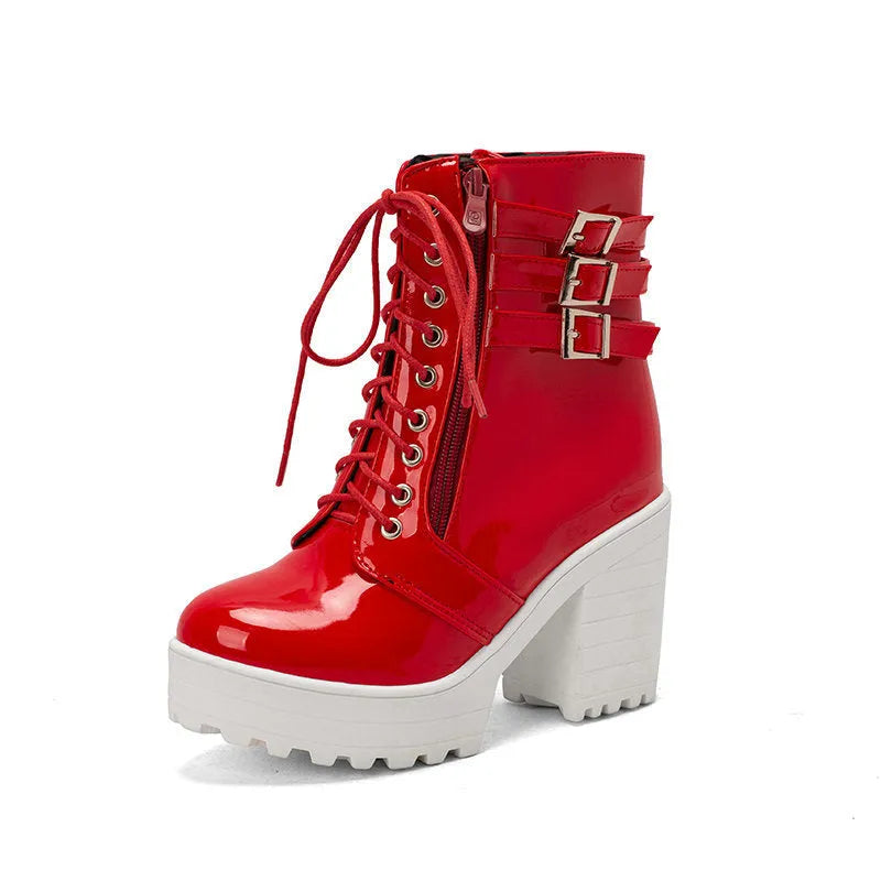 Women's black thick-heeled short boots with lace-up front and round toe on a rubber sole.