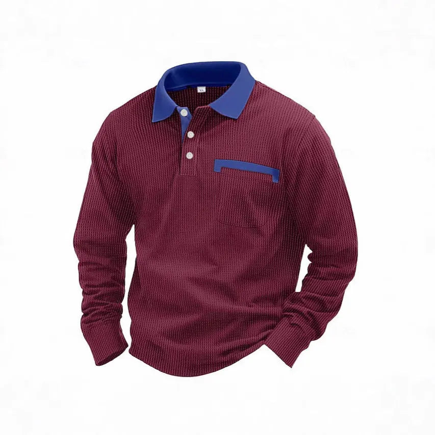 Man wearing a dark grey long-sleeved waffle-texture polo shirt with an asymmetric design detail.