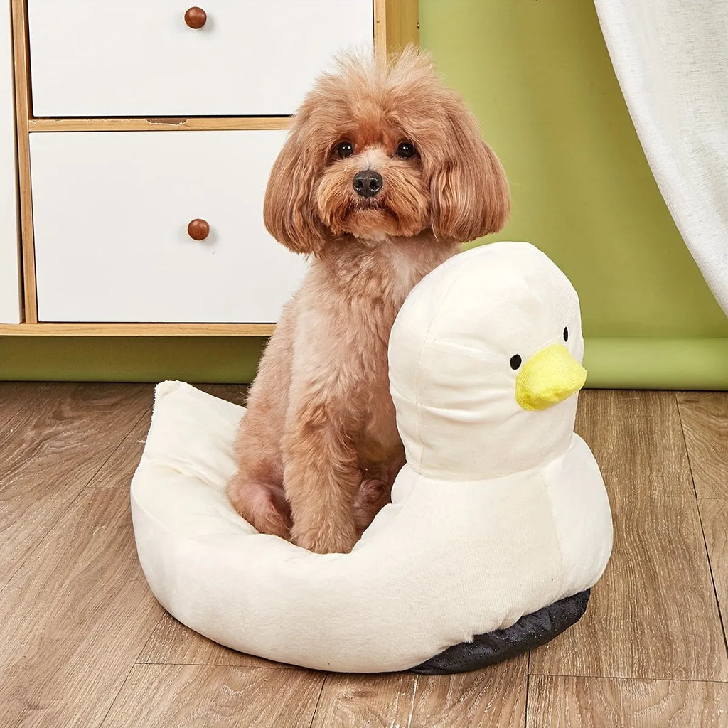 Blue duck-shaped fluffy pet bed for small dogs and cats on a wooden floor.