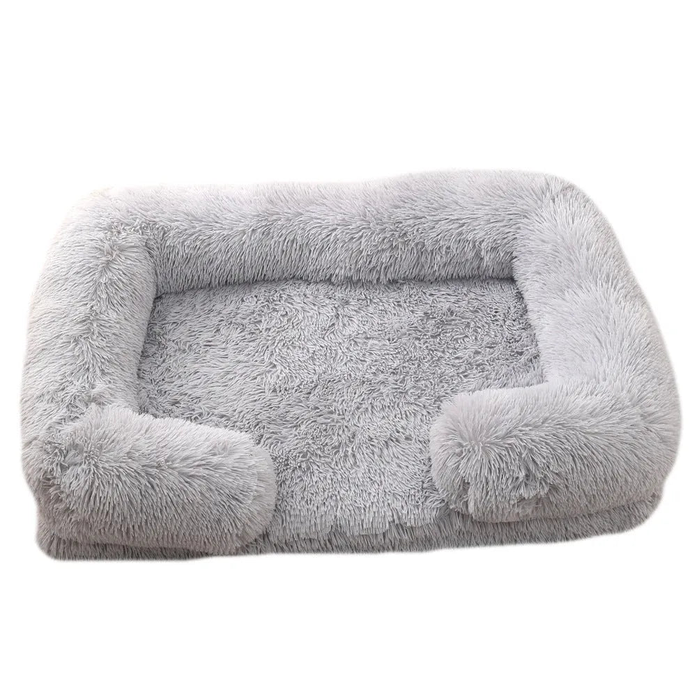 Plush round dog bed in beige brown colour, showing soft texture and round shape with raised edges.