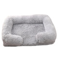 Plush round dog bed in beige brown colour, showing soft texture and round shape with raised edges.