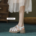 Women's black retro platform sandals with closed toe, chunky rubber sole and buckle fastening